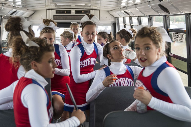 Jay County High School cheerleaders cool off in their bus before they take the stage during the preliminaries of the Indiana State Fair Cheerleading Competition Saturday. KAYTEE LORENTZEN / BSU JOURNALISM AT THE FAIR