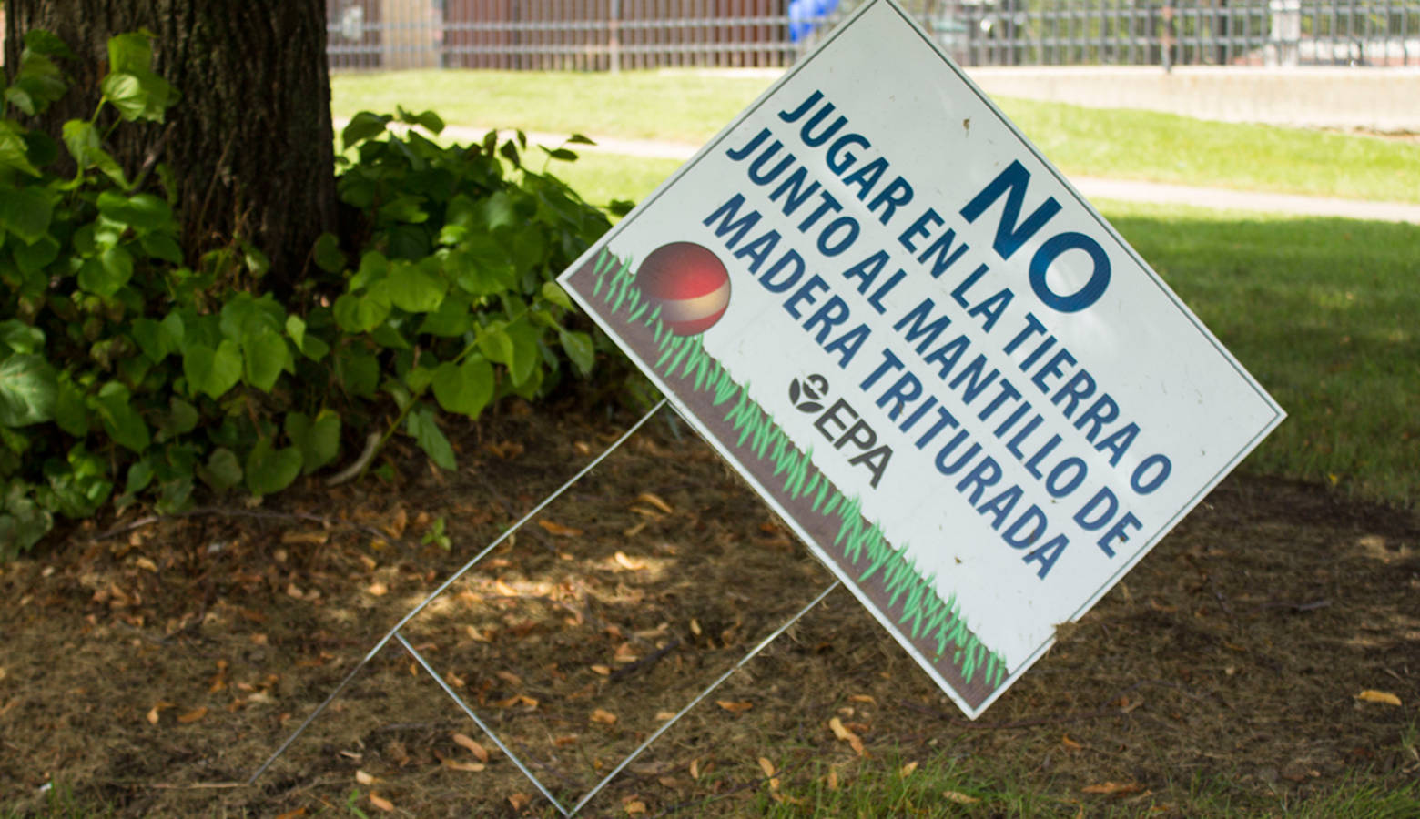 A sign from the Environmental Protection agency warns residents not to play in the soil, which is contaminated with lead and arsenic. (Lauren Chapman/IPBS)