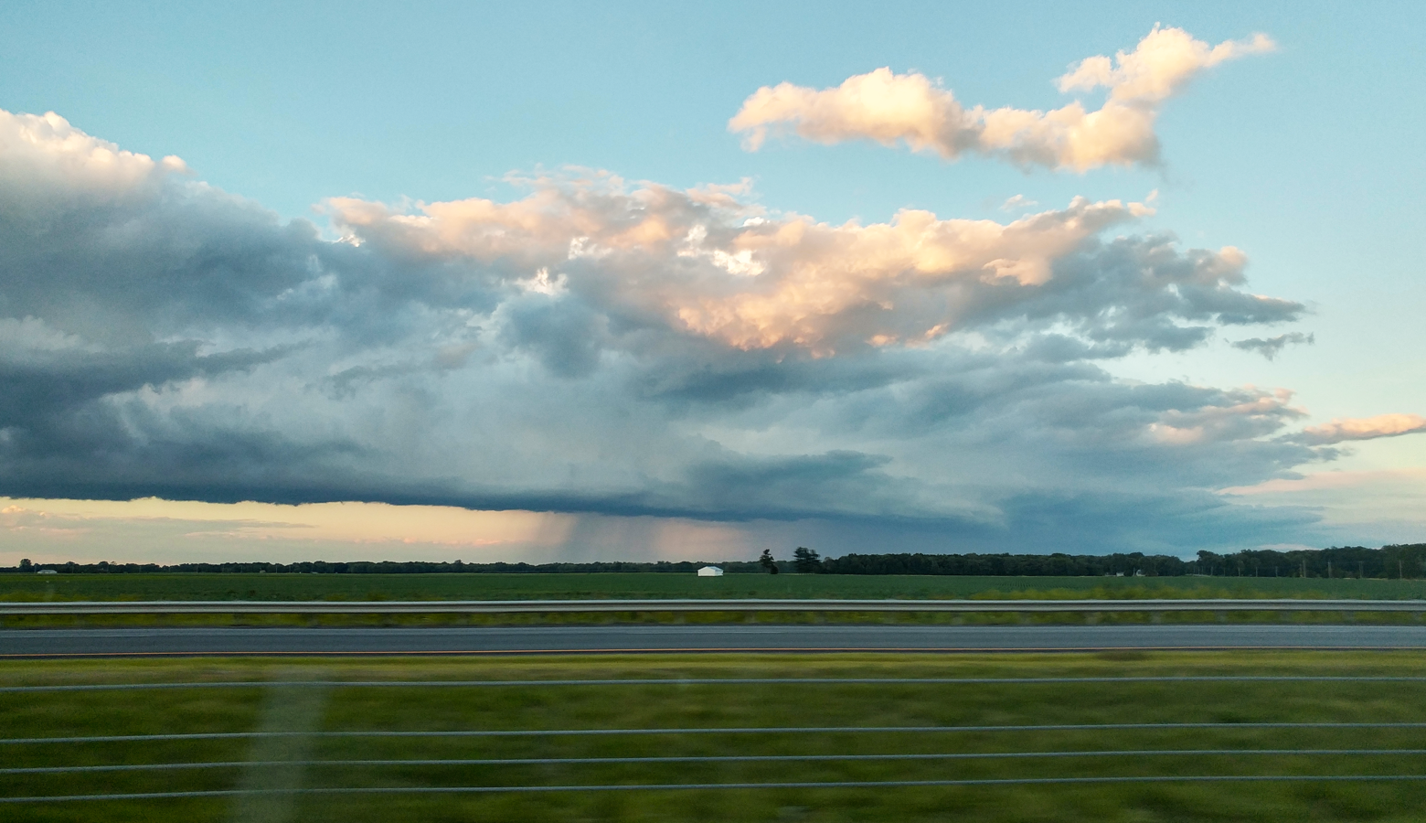 Evening rainclouds shadow growing crops in Northwest Indiana in late June. (Annie Ropeik/IPB News)