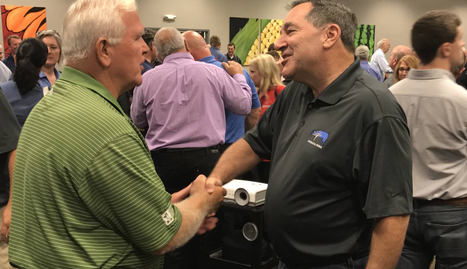 U.S. Sen. Joe Donnelly (D-Indiana), center, speaks with a constituent at the Indiana State Fair (Brandon Smith/IPB News)