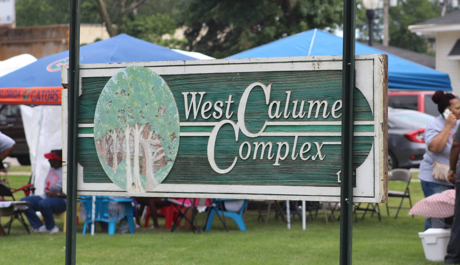The closure of the West Calumet Housing Complex, its old sign seen here at a local block party in July, left a big hole in East Chicago's affordable housing stock that state officials now hope to help fill. (Annie Ropeik/IPB file photo)