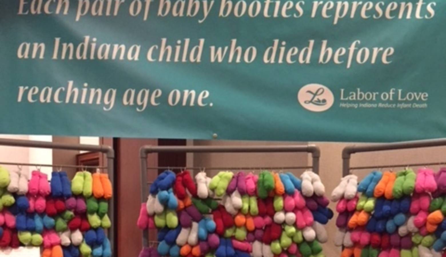 A display at the Indiana Labor of Love summit, each pair of booties represents a Hoosier child who died before their first birthday. (IPB News/Jill Sheridan)