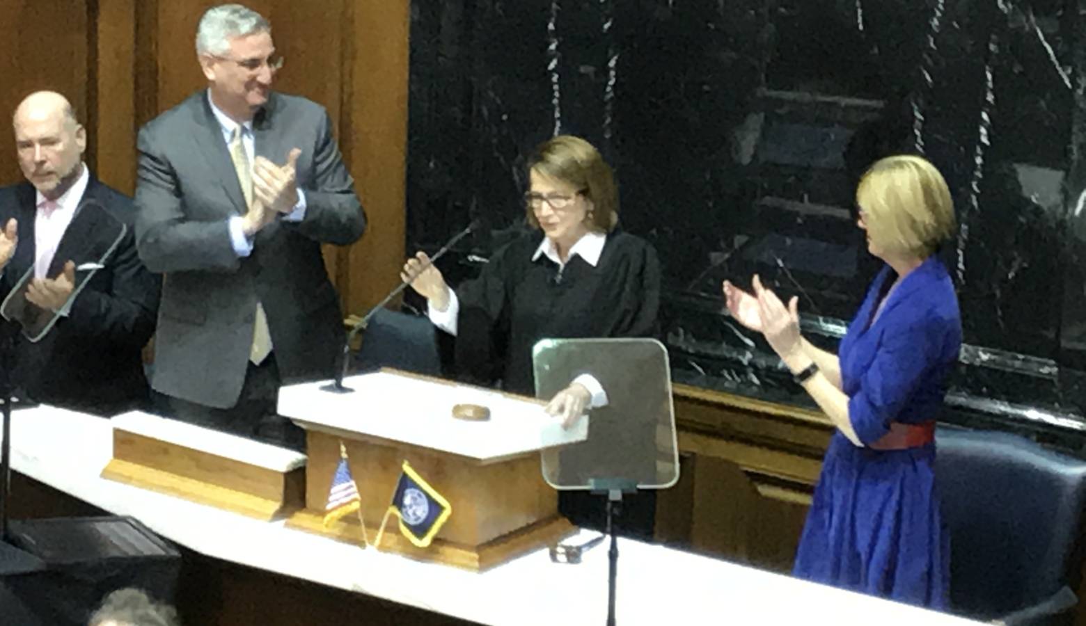 Gov. Eric Holcomb (left) and Lt. Gov. Suzanne Crouch (right) applaud Chief Justice Loretta Rush as she completes her State of the Judiciary address. (Brandon Smith/IPB News)