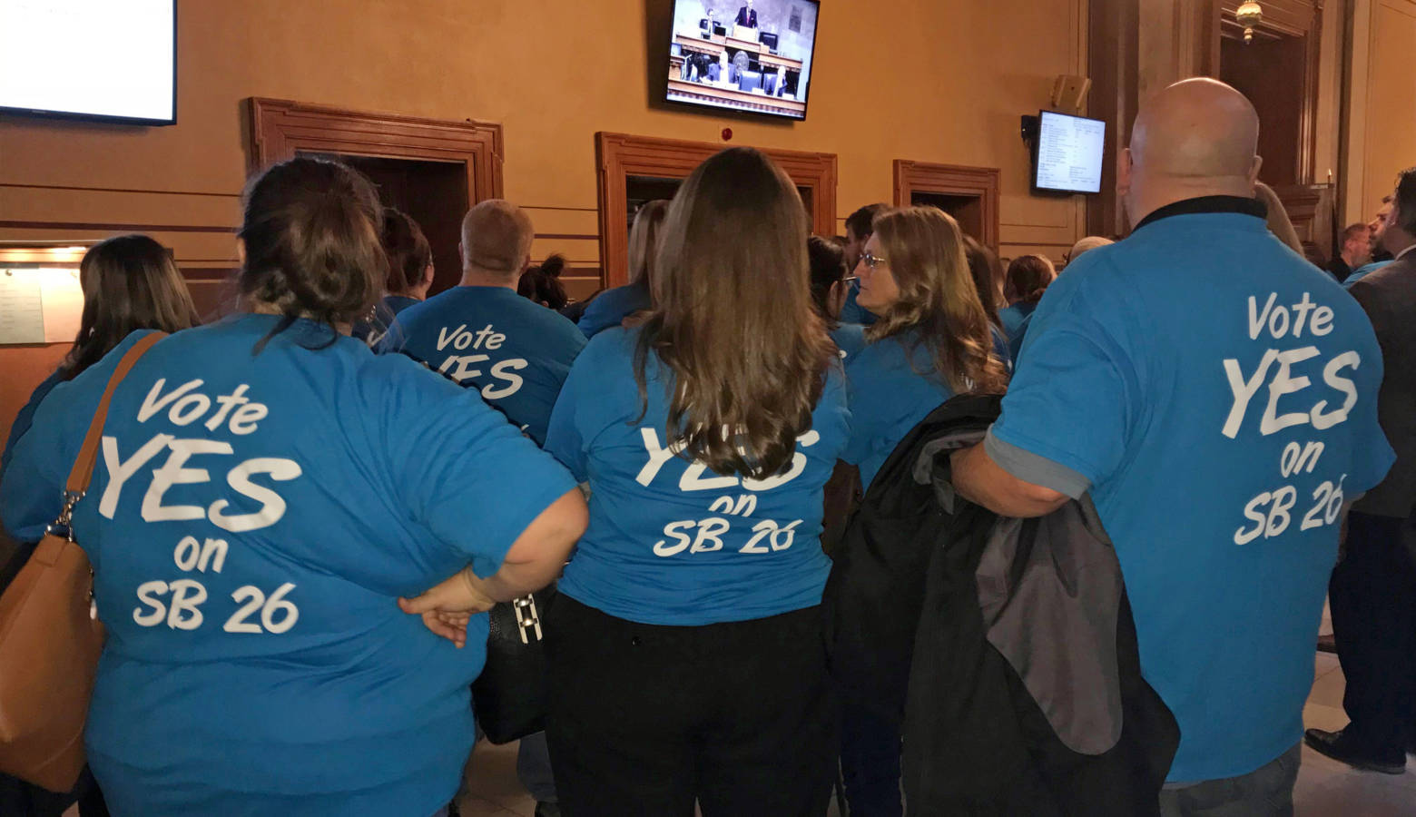 Supporters of the cold beer expansion bill stand outside the Indiana Senate Chamber to watch the committee hearing. (Brandon Smith/IPB News)
