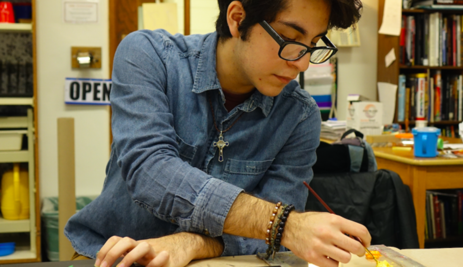 Senior Gustavo Flores works on a series of paintings in the art room at Shortridge High School in Indianapolis on Monday, Nov. 22, 2018.