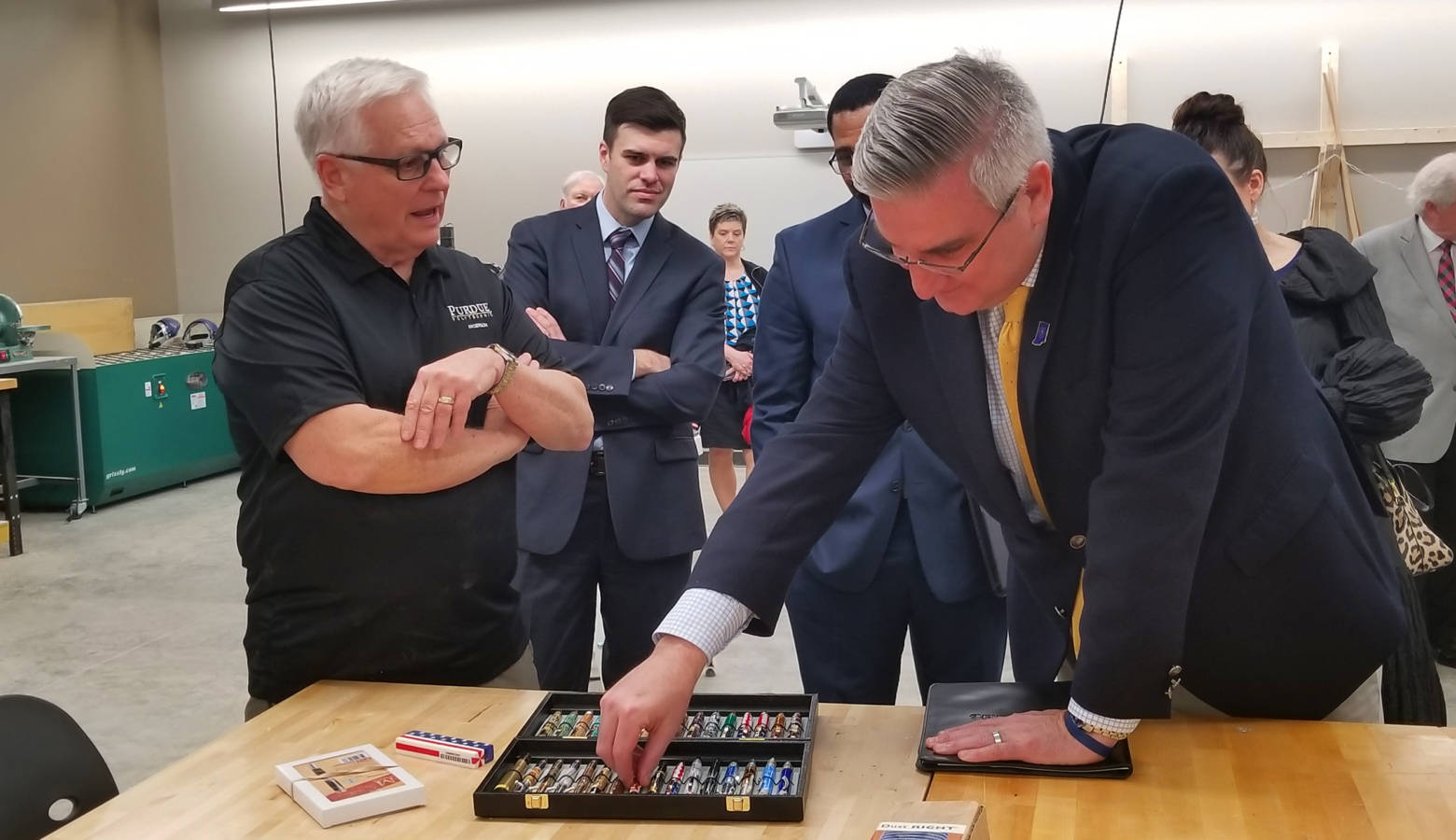 Gov. Eric Holcomb examines pens made by a teacher at the Purdue Polytechnic Institute in Anderson. (Samantha Horton/IPB News)