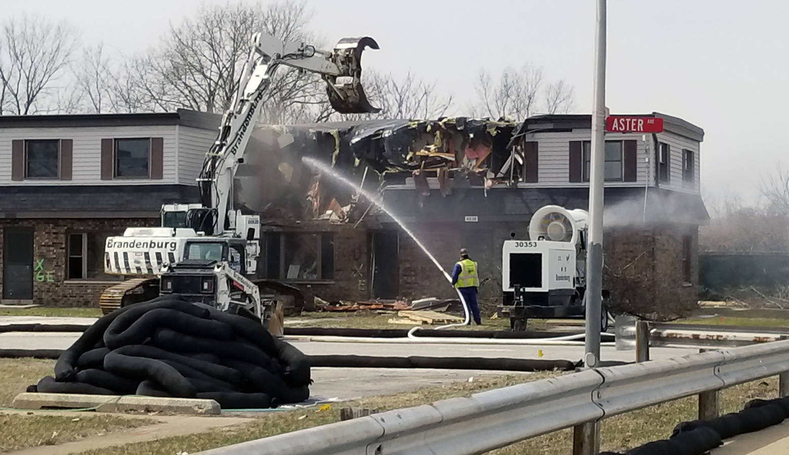 Crews begin tearing down a portion of the West Calumet Housing Complex on April 2. They drench the debris to prevent the spread of lead and arsenic contamination to the surrounding neighborhood. (Lauren Chapman/IPB News)