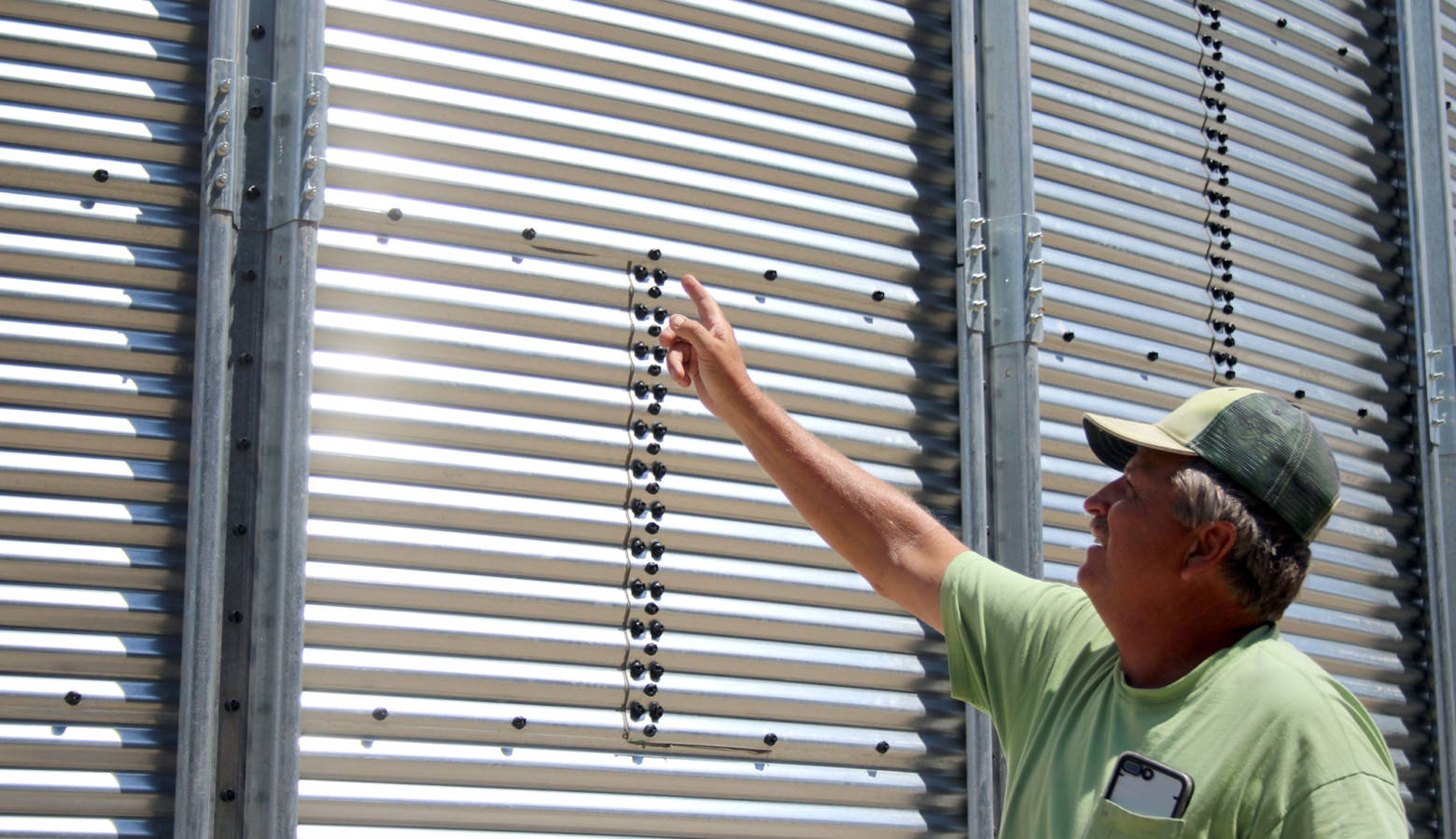 Mike Morehouse, a fifth generation farmer in Elkhart, Indiana, points to his new grain bin. (Samantha Horton/IPB News)