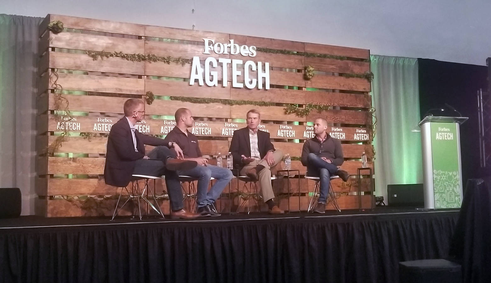 (From left to right) Reynolds Farm Equipment CEO Mitch Frazier talks with panelists AgNext CEO Troy Fiechter, farmer Jim Kline, and Taranis head of marketing Alex Whitley during Forbes AgTech Summit in Indianapolis. (Samantha Horton/IPB News)