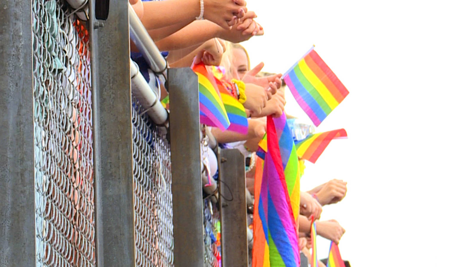 Students at a Roncalli football game wave rainbow flags to support counselor Shelley Fitzgerald. State Superintendent Jennifer McCormick says the situation brought attention to voucher schools with discriminatory practices. (Lauren Chapman/IPB News)