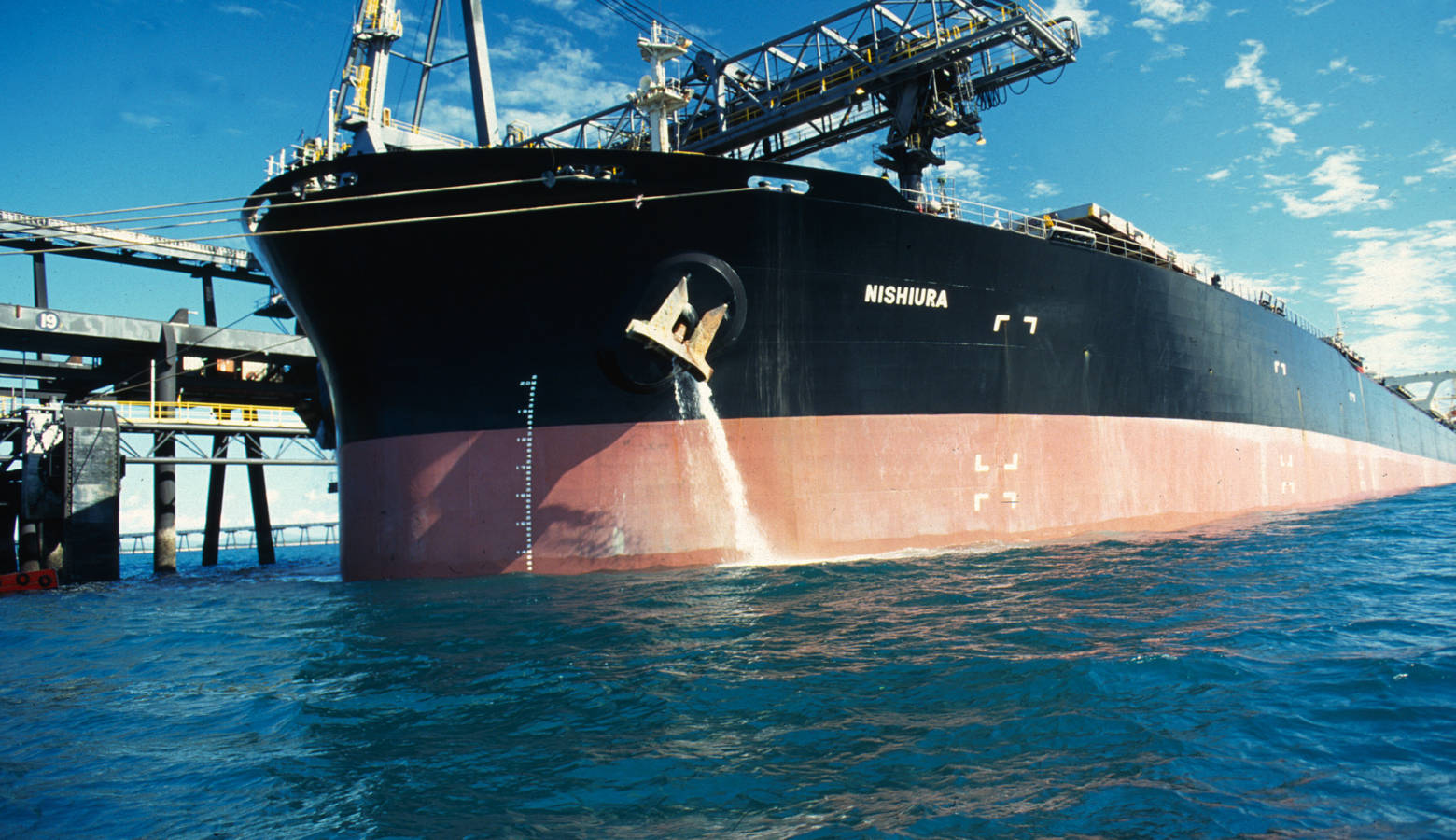 A carrier ship releasing ballast water in the 1990's (CSIRO/Wikimedia Commons)