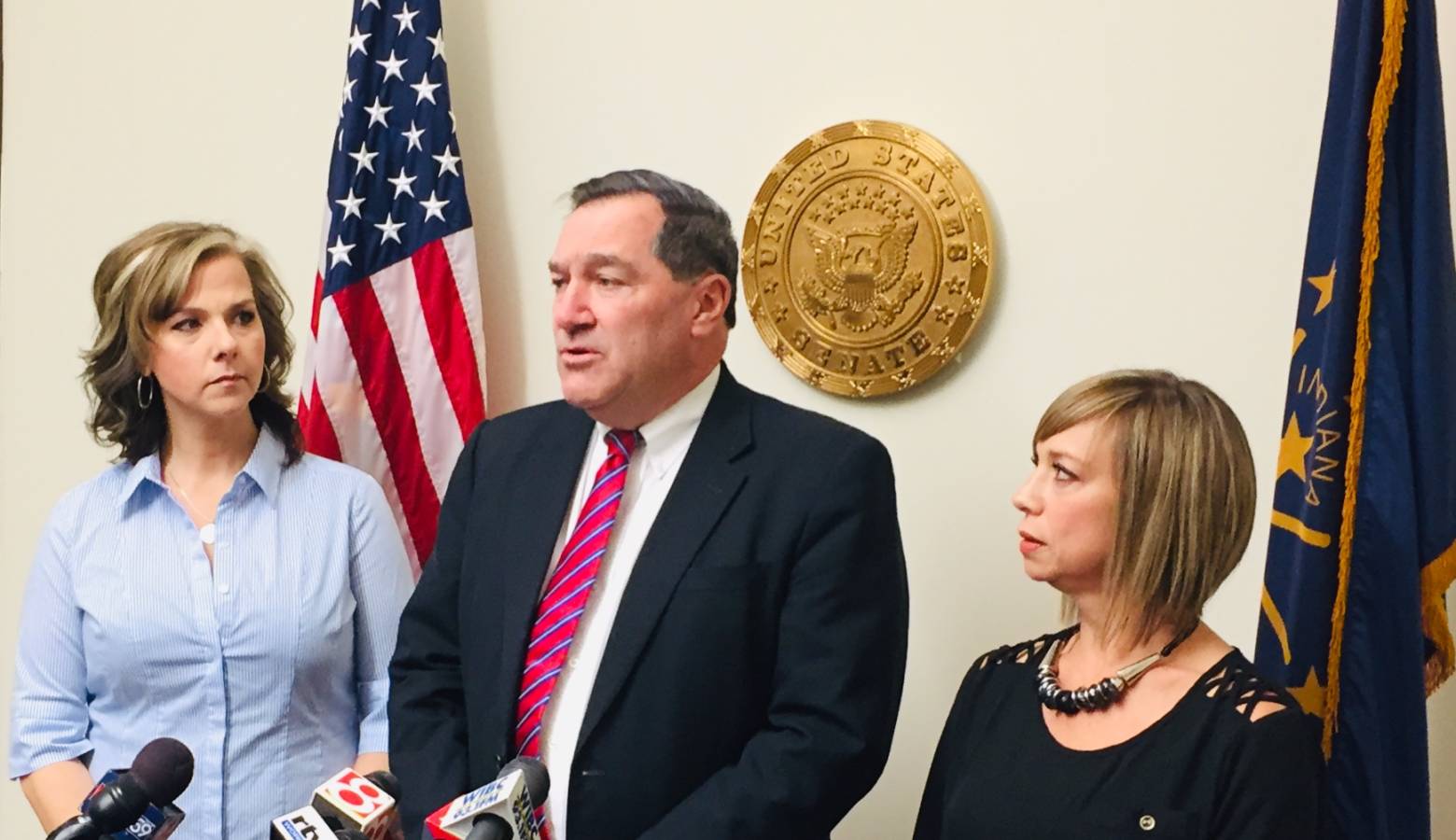 U.S. Sen. Joe Donnelly (D-Ind.) stands with If It Was Your Child moms. (Jill Sheridan/IPB News)