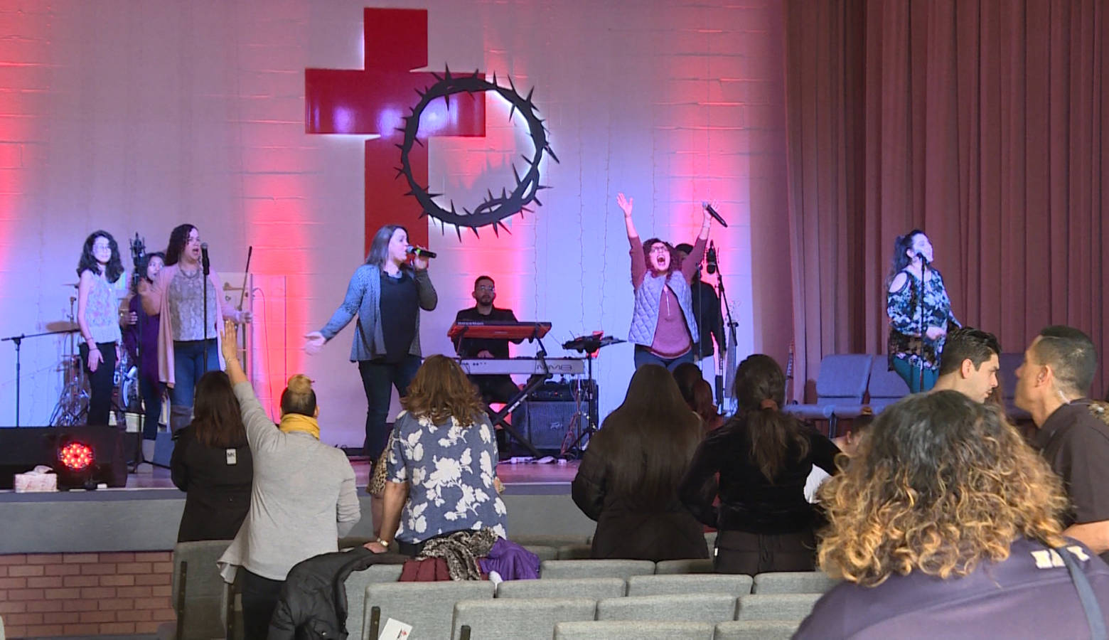 Members of The Cross Church — nondenominational, multicultural church in East Chicago — sing praise songs at one of their Sunday services. (Tyler Lake/WTIU)