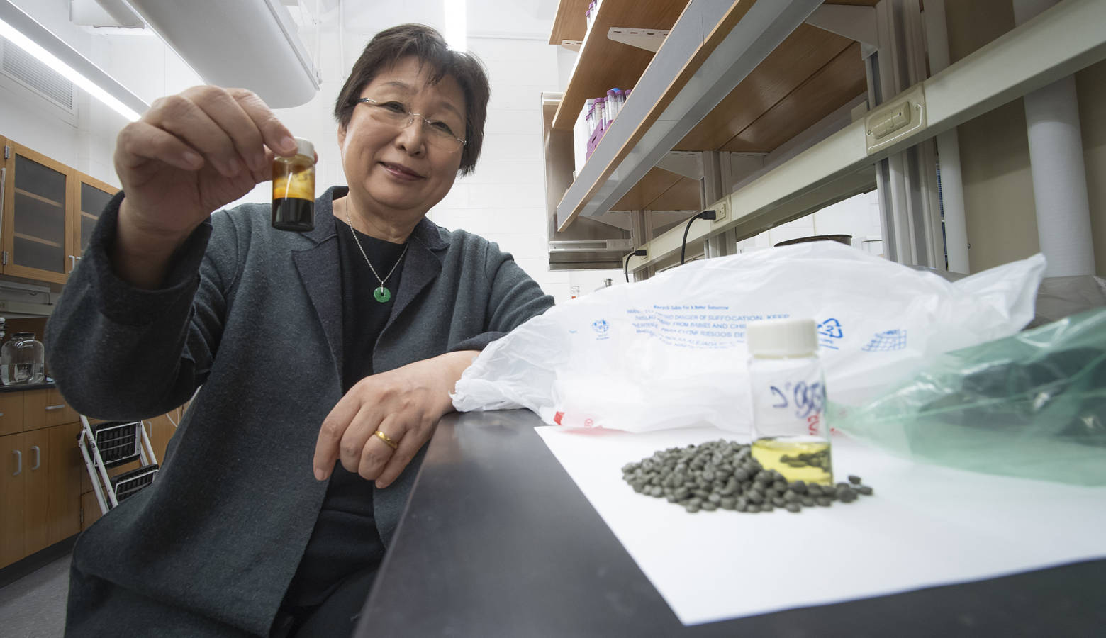 Before the polyolefin plastics can get dissolved in the supercritical water, they're first turned into pellets like the ones in the bottle Linda Wang is holding (Purdue Research Foundation/Vincent Walter)