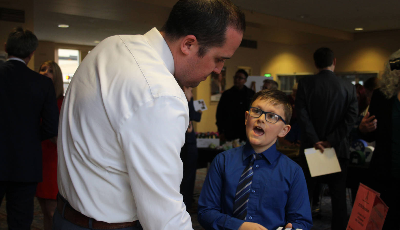 Mayflower Mill Elementary School third grader David Rowe explains his classroom's business to volunteer business judge First Merchants Bank Commercial Relationship Manager Vice President Greg Whited. (Samantha Horton/IPB News)