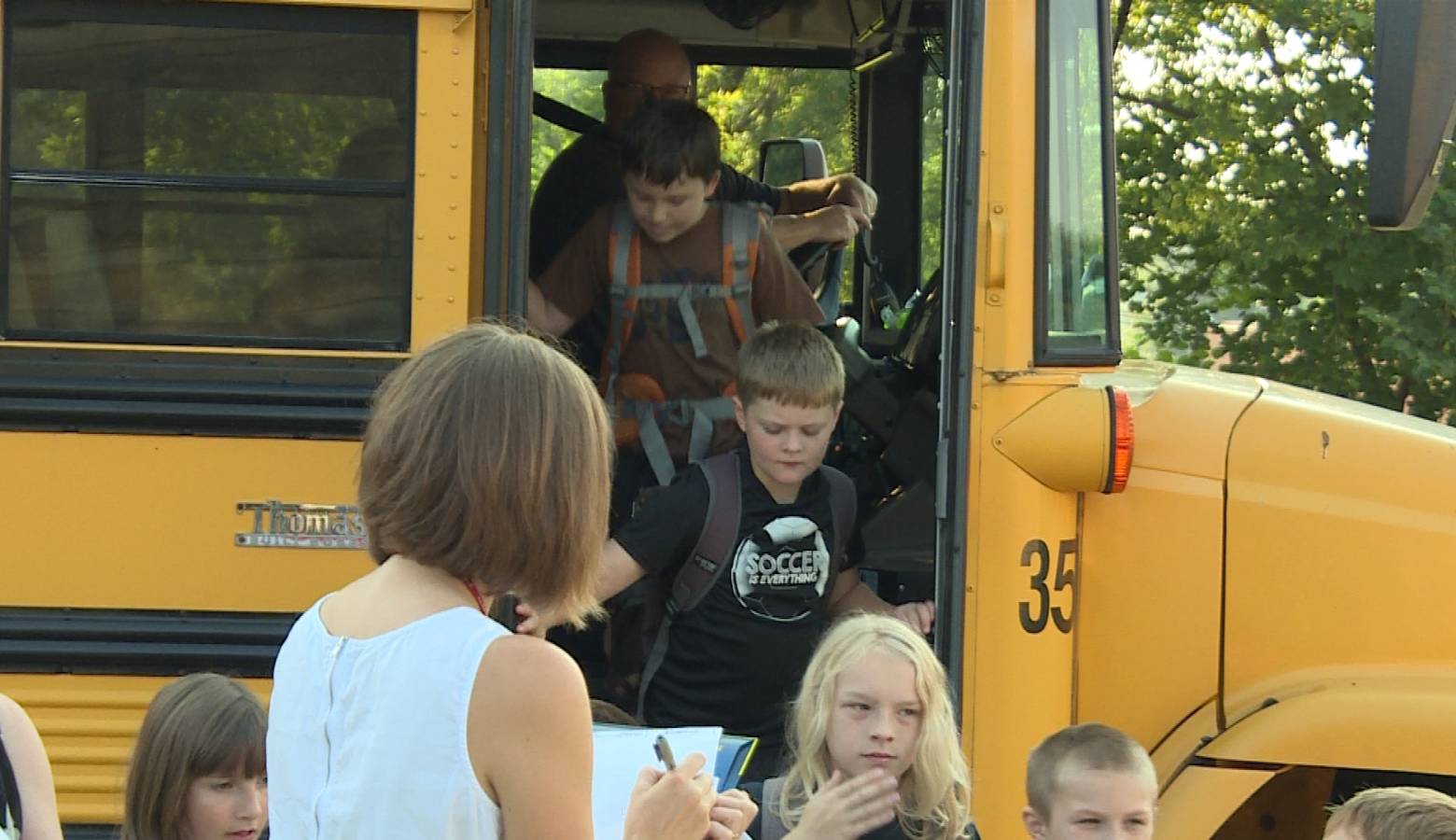 Kids getting off a school bus (WFIU/WTIU)