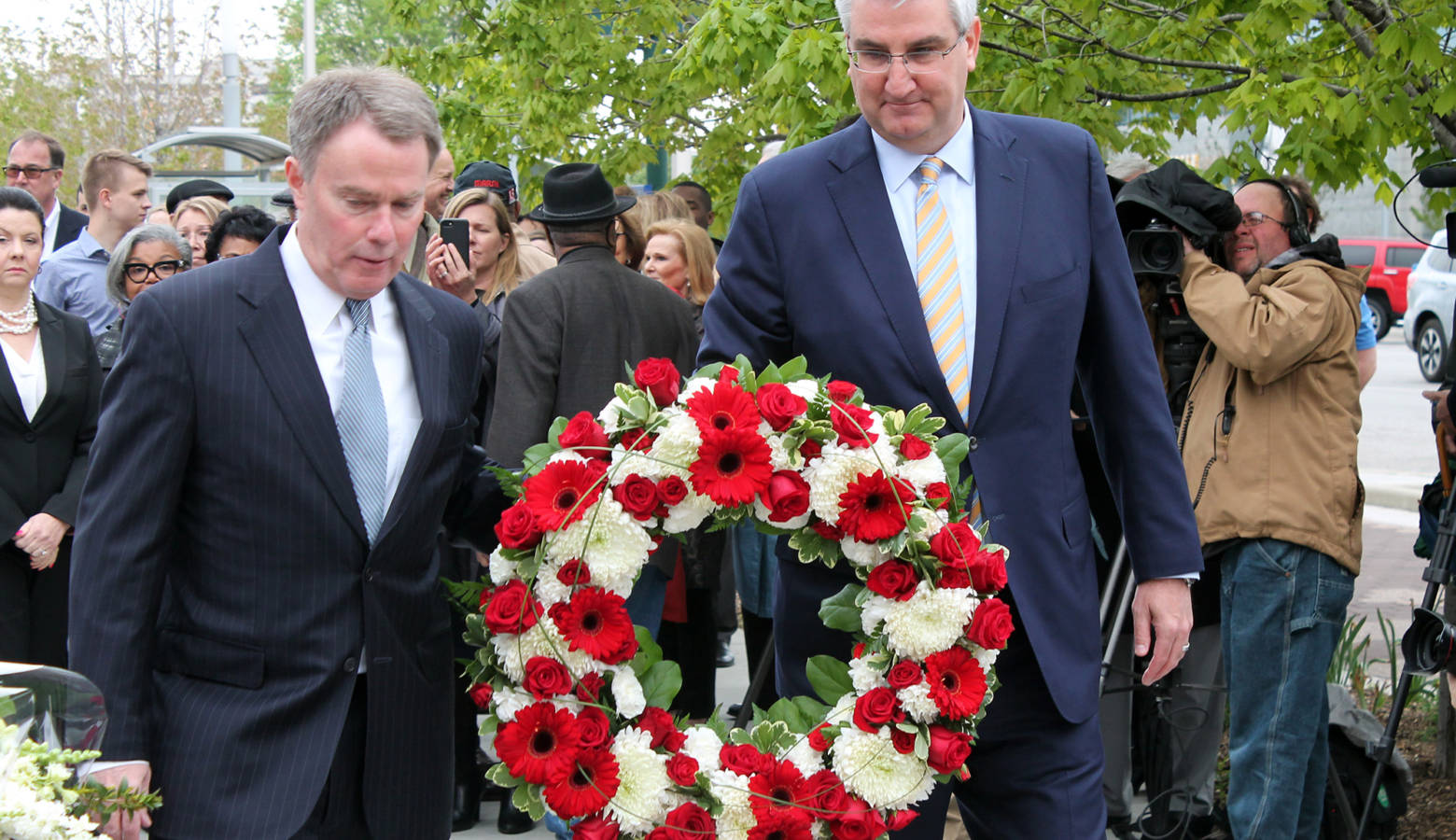 Indianapolis Mayor Joe Hogsett and Gov. Eric Holcomb lay a wreath at Richard Lugar Plaza in Indianapolis. (Lauren Chapman/IPB News)