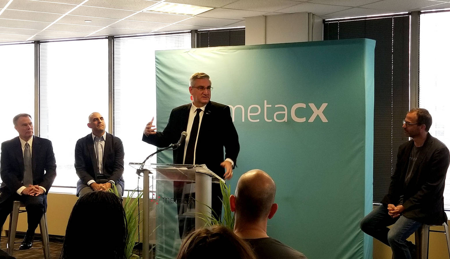 Gov. Eric Holcomb joined by city and MetaCX leaders gives remarks on the tech companies growth. (Samantha Horton/IPB News)