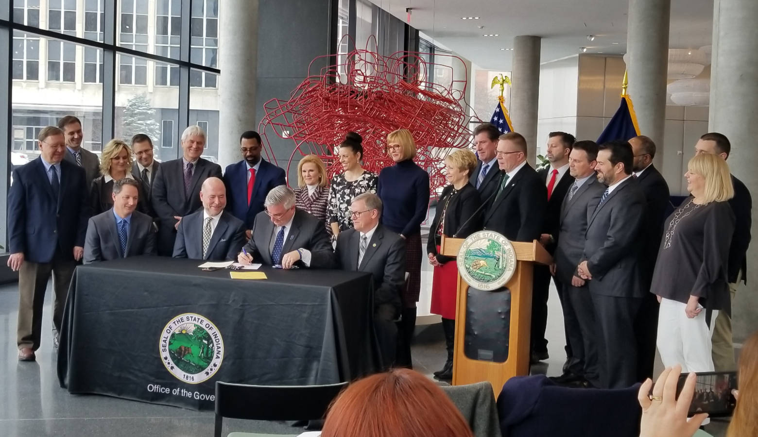 Gov. Eric Holcomb signs workforce bills with Indiana lawmakers and business leaders on March 21. (Samantha Horton/IPB News)