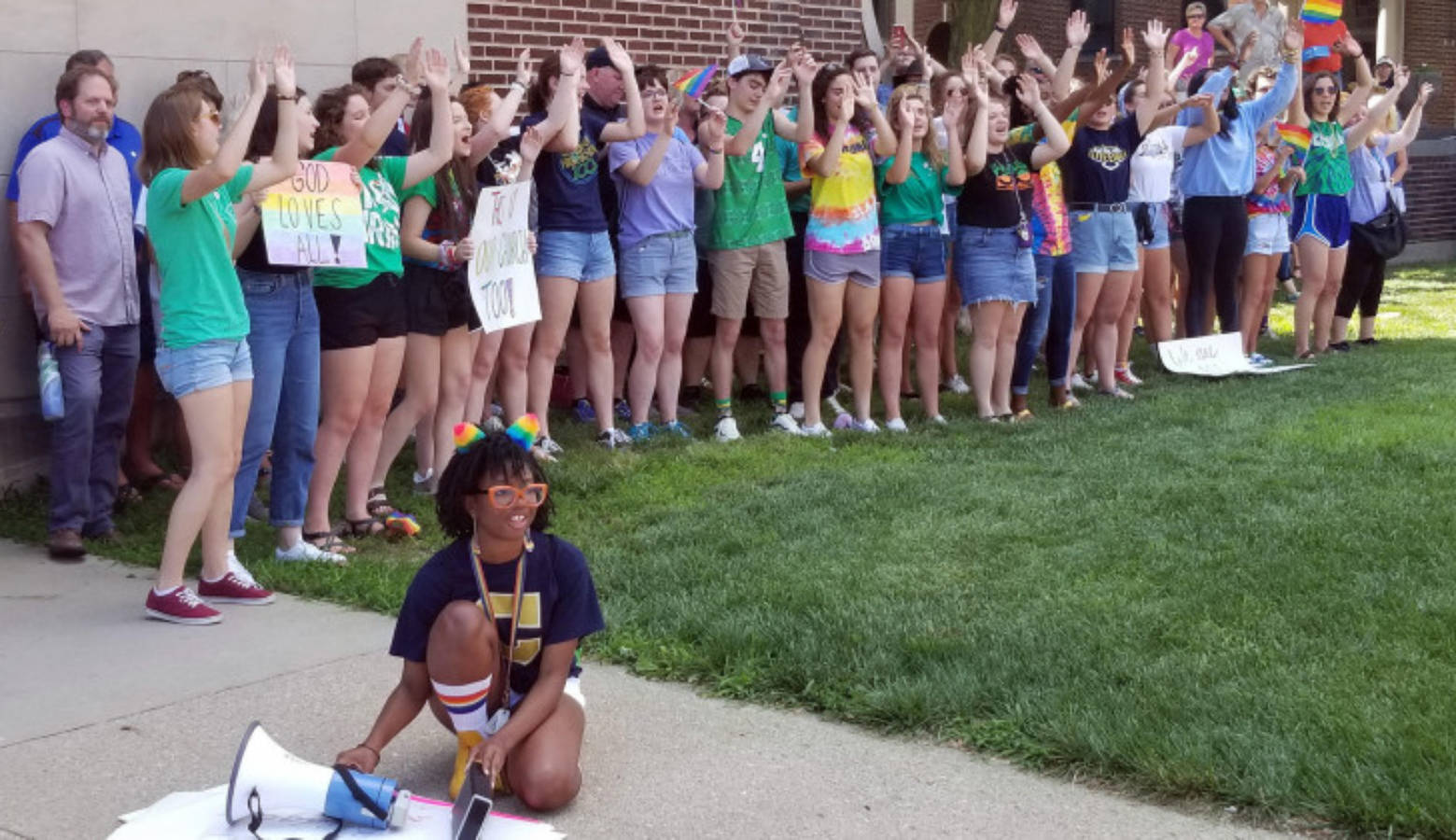 Student organizer Brooklynn Thorpe uses a megaphone to amplify music as fellow students lead school chants and cheers outside of the Archdiocese of Indianapolis during a protest Thursday, June 27, 2019.