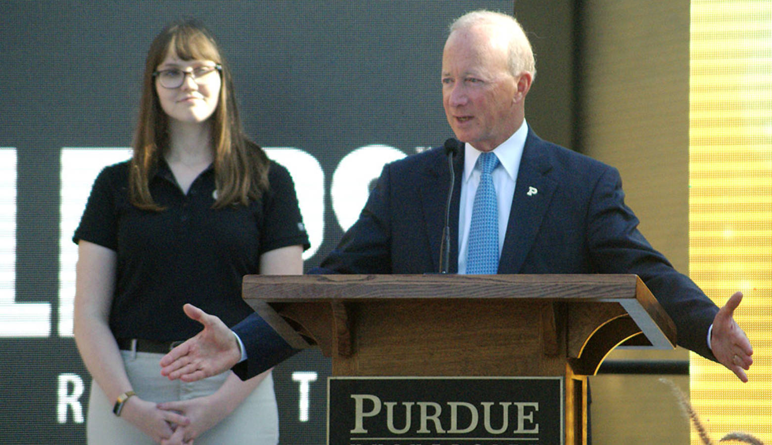 Purdue President Mitch Daniels, with senior Michaela Rumple standing to his left, tells attendees what the new Engineering and Polytechnic Gateway Complex will mean for students and businesses. (Samantha Horton/IPB News)