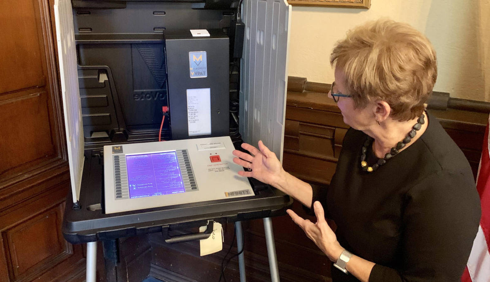 Secretary of State Connie Lawson demonstrates the use of a paper audit trail on an electronic voting machine. (Brandon Smith/IPB News)