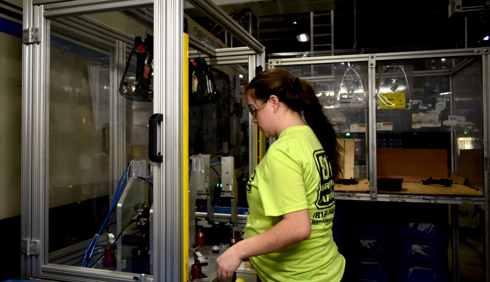 A worker at a factory in North Vernon, Indiana, works with a plastics manufacturing robot. (Justin Hicks/IPB News)