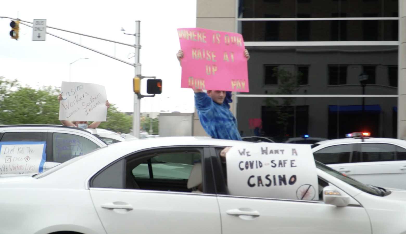 Casino workers hold signs from their cars in downtown Indianapolis. (Alan Mbathi/IPB News)