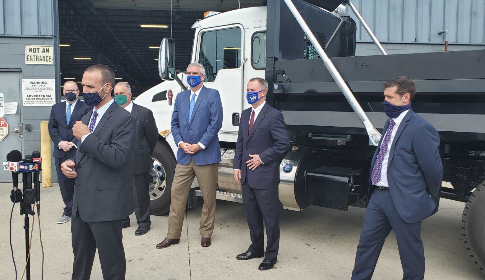 Palmer Trucks CEO John Nichols discusses the company's decision to expand during the coronavirus pandemic with Gov. Eric Holcomb, Indianapolis Mayor Joe Hogsett and other officials in attendance. (Samantha Horton/IPB News)
