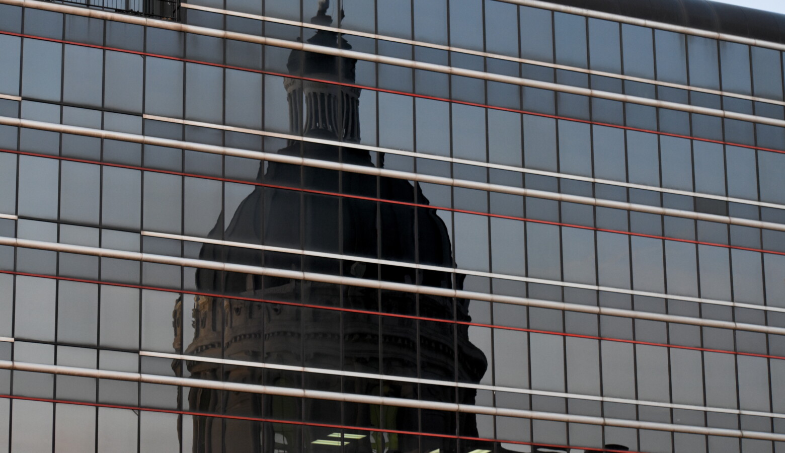 The reflection of the Indiana Statehouse in a nearby building. (Justin Hicks / IPB News)