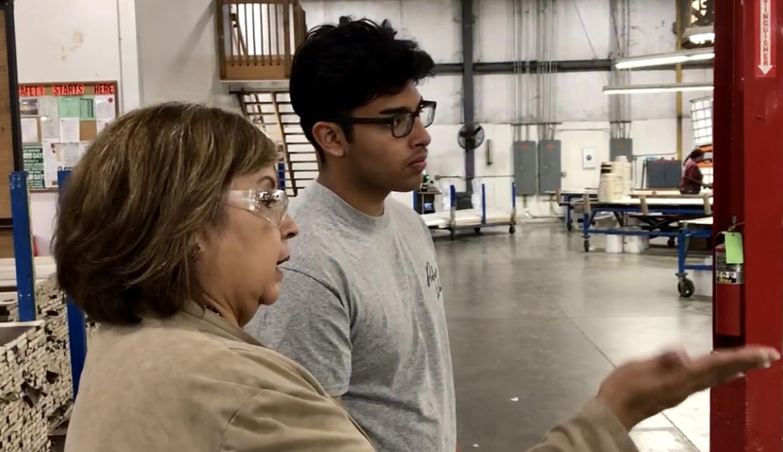 Chris Camacho, a youth apprentice in a similar program in Elkhart County, learns about the operations of the factory on his first day. (Justin Hicks/IPB News)