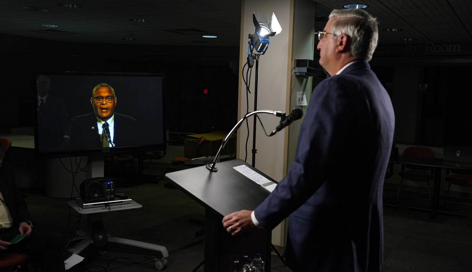 Due to COVID-19 precautions, the three gubernatorial candidates and the moderator were in separate rooms at WFYI studios in Indianapolis. Here, Republican Gov. Eric Holcomb watches Democrat Dr. Woody Myers speak. (Darron Cummings/Associated Press)