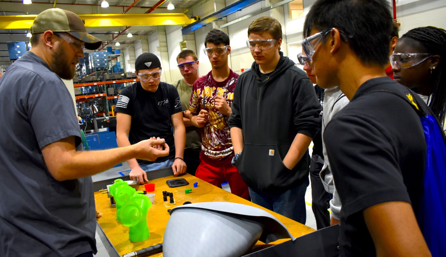 Jeremey Rorie shows Penn High School students what he does for work at B&B Molders in Mishawaka. (Justin Hicks/IPB News)