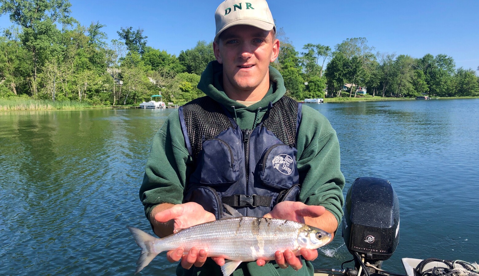 DNR Division of Fish &Wildlife fisheries aide Aaron Voirol holds a cisco captured at Crooked Lake during a 2019 fish community survey. (Courtesy of Indiana DNR)