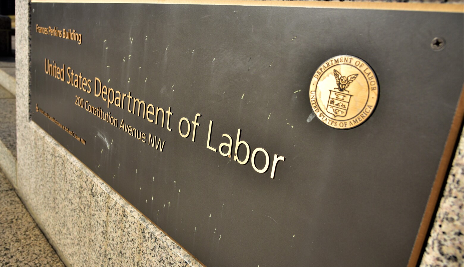 A placard in front of the U.S. Department of Labor. (Justin Hicks/IPB News)
