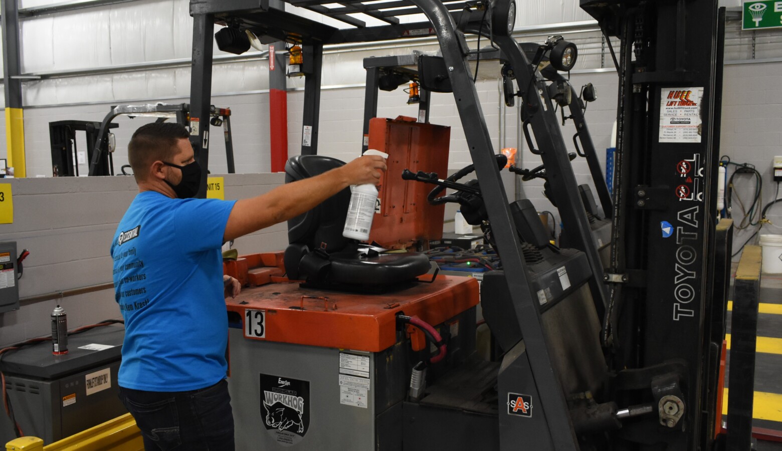 A worker sprays down a forklift in an Elkhart factory in accordance with the company's COVID-19 safety standards. (Justin Hicks/IPB News)
