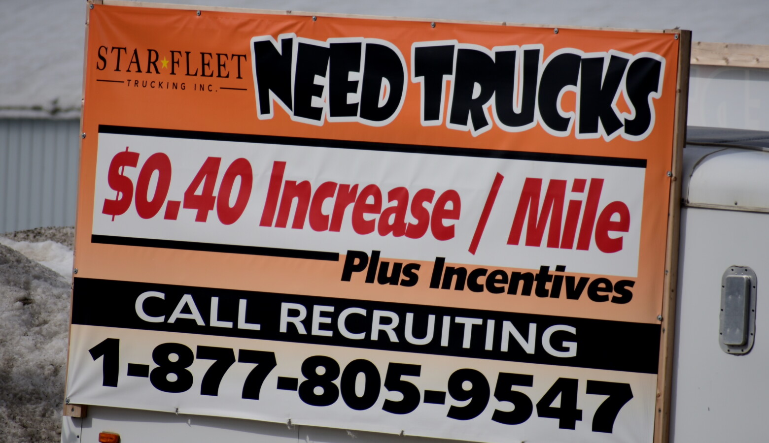 A sign from a trucking company in Nappanee, Indiana recruits truckers. In some industries, like trucking, worker shortages were exacerbated by the pandemic. (Justin Hicks/IPB News)