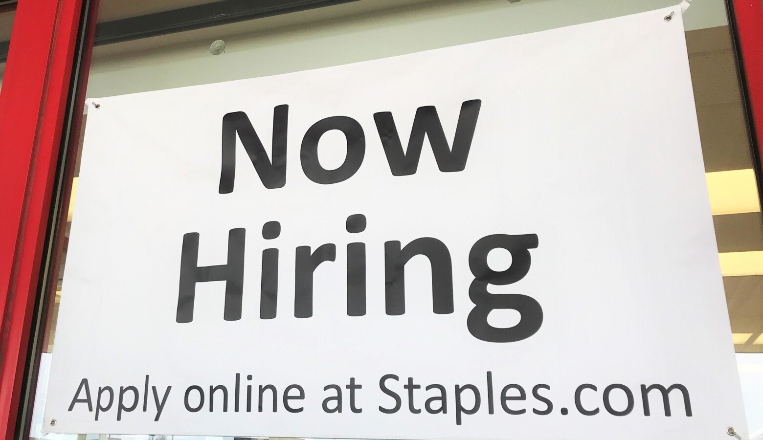A "Now Hiring" sign on the front of a Staples in Elkhart, Indiana. (Justin Hicks/IPB News)