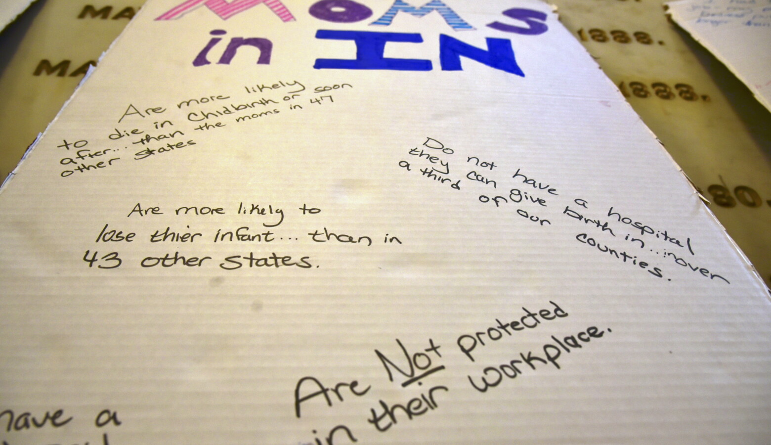 A poster advocating for better policies for women from a Hoosier Action statehouse rally during the 2021 legislative session. (Justin Hicks/IPB News)
