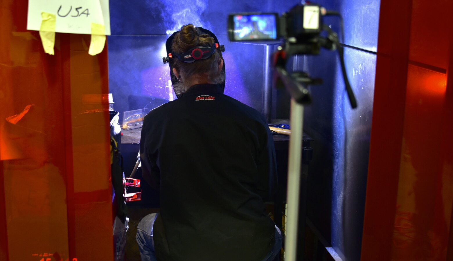 A student at the Elkhart Area Career Center welds a design for the SkillsUSA competition while being recorded on camera. (Justin Hicks/IPB News)