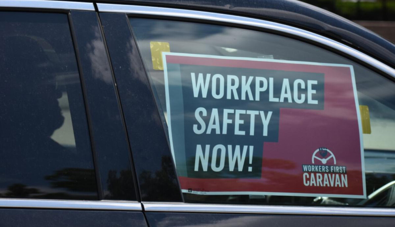 A sign in a car caravan at a labor rally in 2019 reads "Workplace Safety Now!" (Justin Hicks/IPB News)