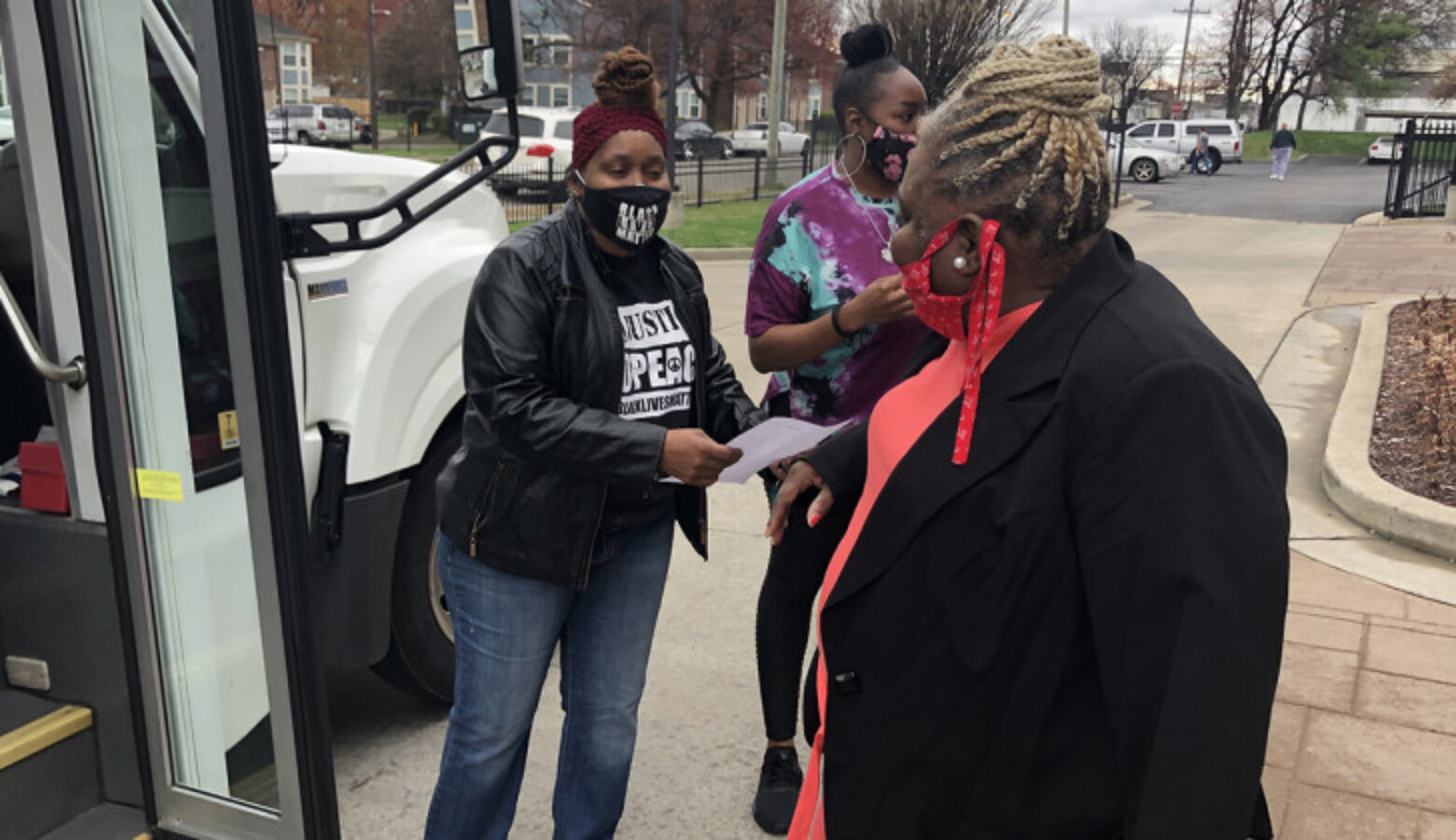 Harriett Rankin, a member of Black Lives Matter Louisville, helps residents board a van to get their second dose of the COVID-19 vaccine.