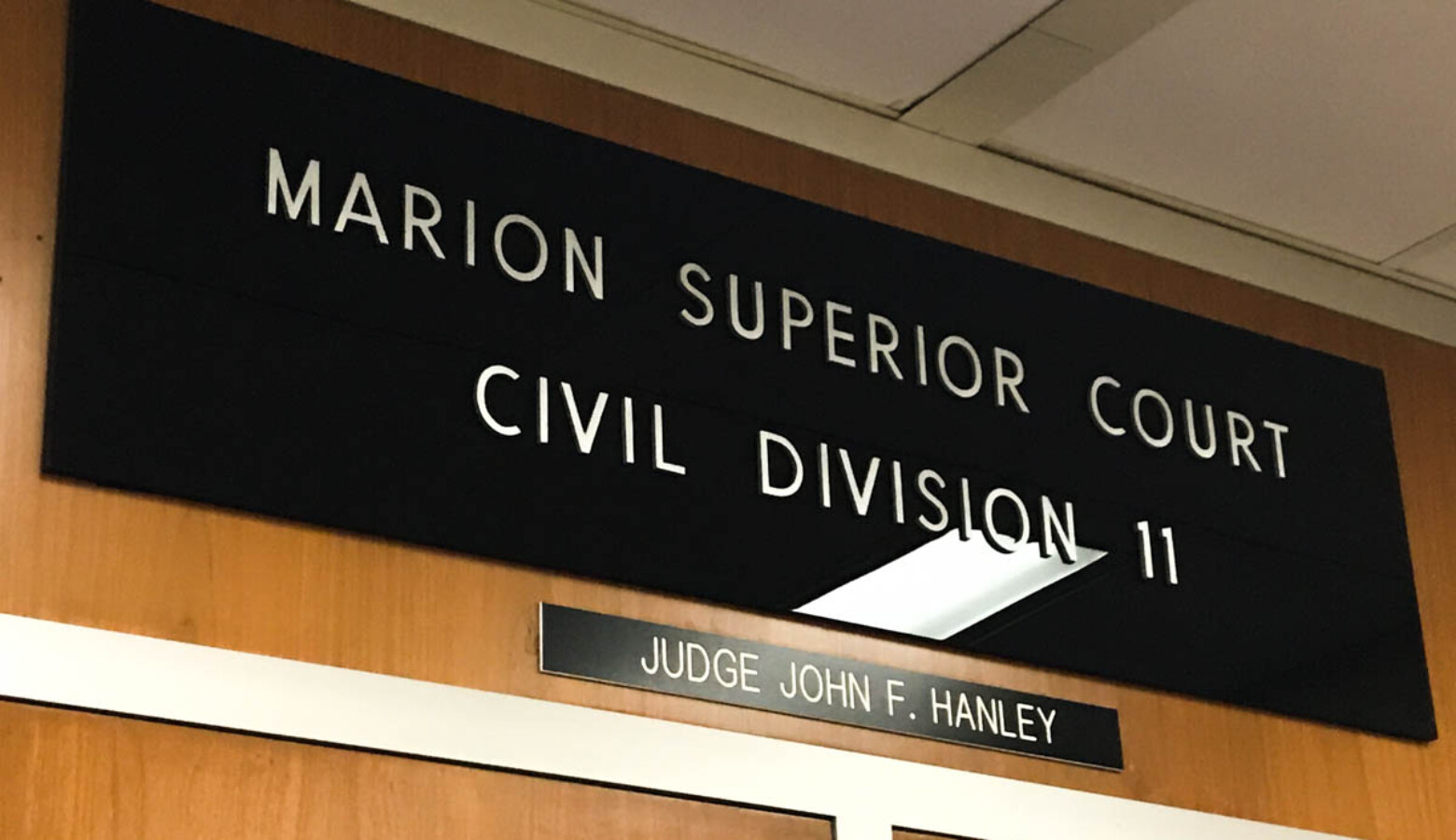 The plaque above a Marion County Superior Court where a hearing was held Wednesday regarding a possible injunction to keep federal unemployment benefits in Indiana. (Justin Hicks/IPB News)