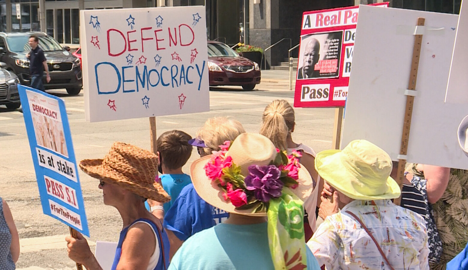 Demonstrators gathered in front of U.S. Sen. Todd Young (R-Ind.)'s office before marching to the office of U.S. Sen. Mike Braun (R-Ind.) a few blocks away. (Lauren Chapman/IPB News)