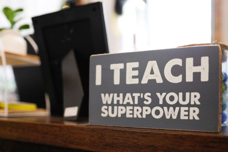 A sign reading, “I teach; what’s your superpower?” on fourth grade teacher Heather Veatch’s desk Oct. 1 at East Washington Academy.