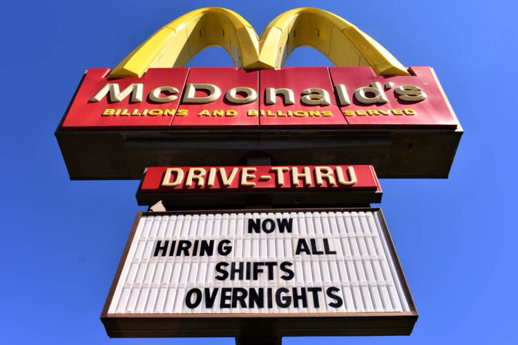 A McDonald's sign includes the message, Now Hiring All Shifts Overnights