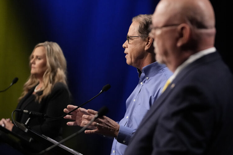 Jennifer McCormick is a White woman with blonde hair, wearing a black suit. Mike Braun is a White man, balding with gray hair. He is wearing glasses and a blue shirt. Donald Rainwater is a White man, bald, with a white goatee. He is wearing glasses and a dark suit.