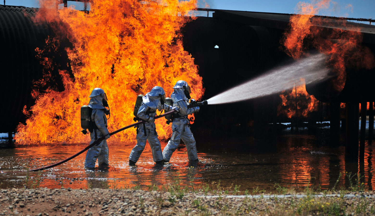 U.S. Air Force firefighters work to extinguish a simulated engine fire at Cannon Air Force Base in New Mexico in 2012.