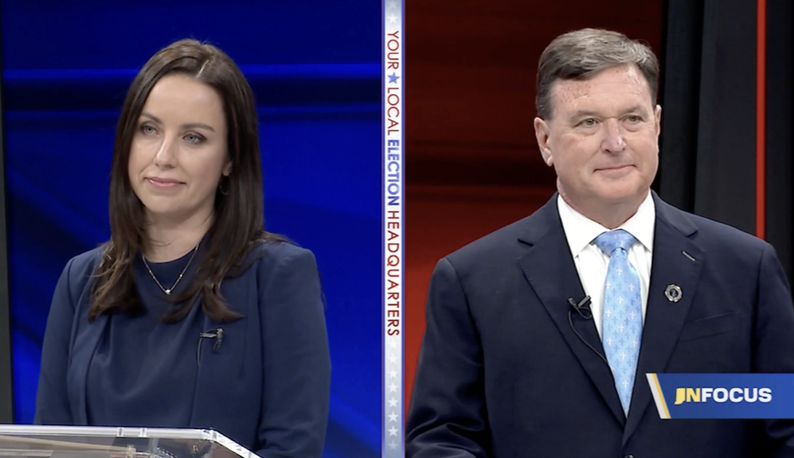 A screenshot of the Indiana attorney general candidate debate. Destiny Wells is a White woman with dark hair. She is wearing a dark blue jacket and top. Todd Rokita is a White man with dark, graying hair. He is wearing a dark blue suit with a white shirt and light blue and white tie.