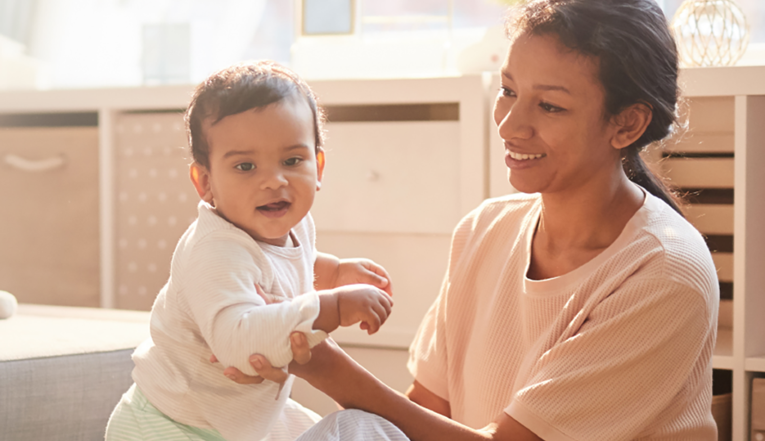 A woman holds her baby.